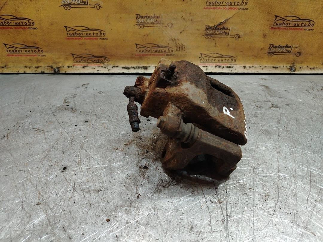 Суппорт передний правый L62K3K Nissan Primera - Фото 1