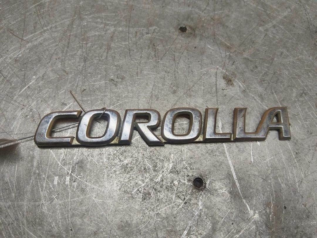 Эмблема 0UGLOY Toyota Corolla - Фото 1